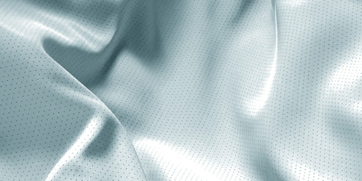 Close-up of Fractel AeroLITE running fabric, a perforated pale blue mesh