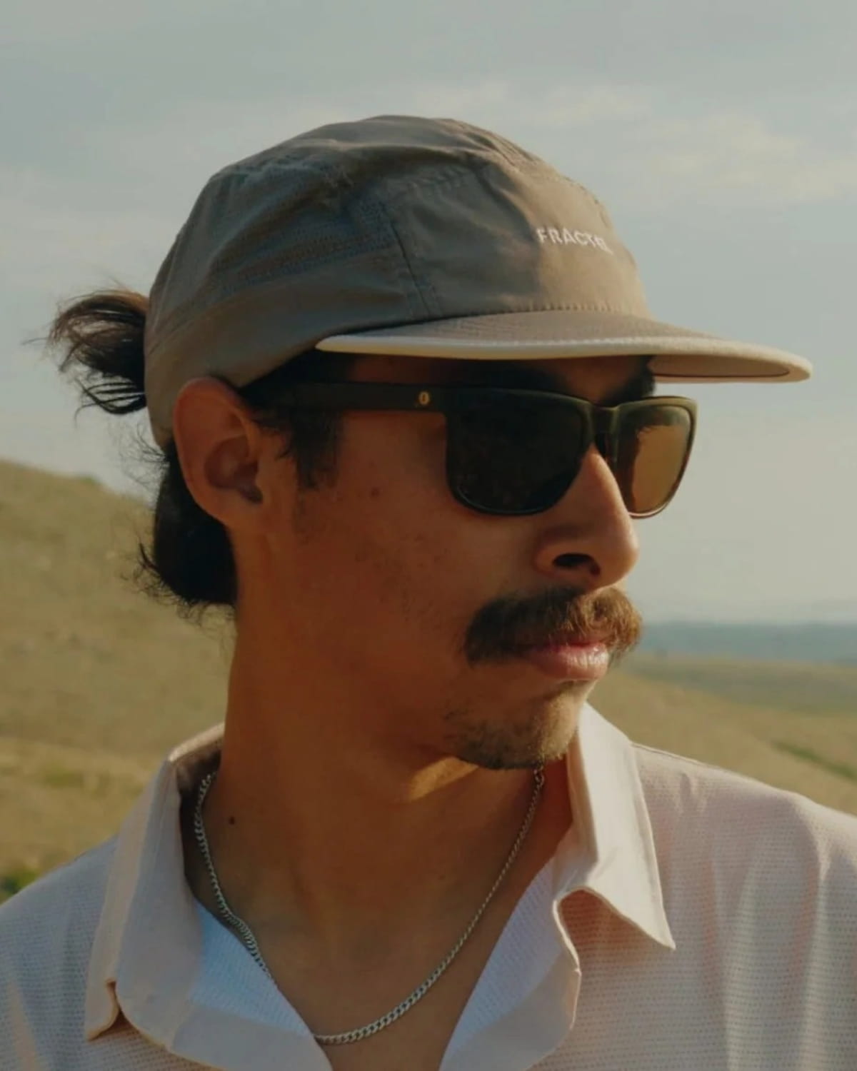 A Fractel ambassador trying on running hats in the Rocky Mountains