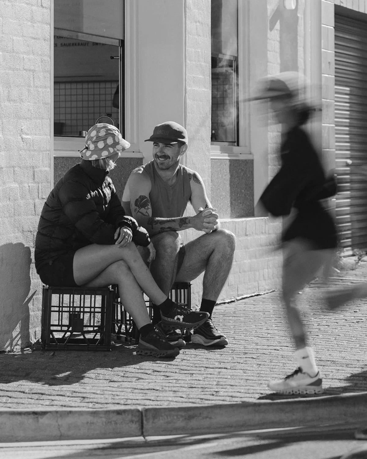 People sitting on the Melbourne roadside waiting for the Fractel running gear sale