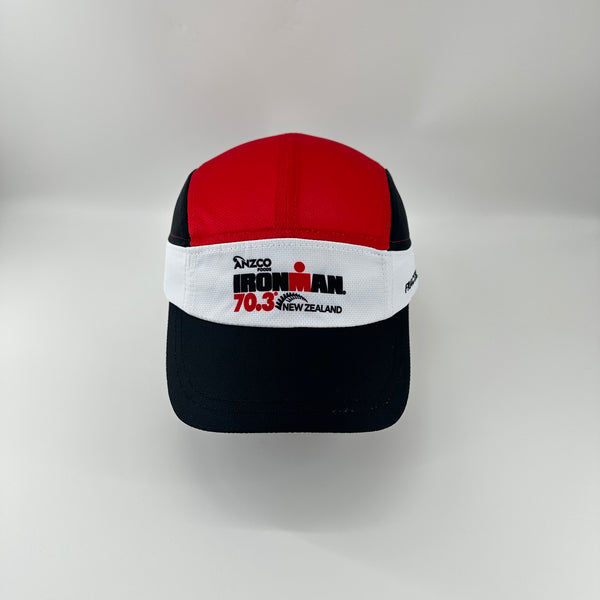 A red, white, and black M-Series cap featuring the 'Ironman 70.3 New Zealand' logo on the front white band, set against a plain light gray background.