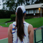 Women wearing a white singlet on running track