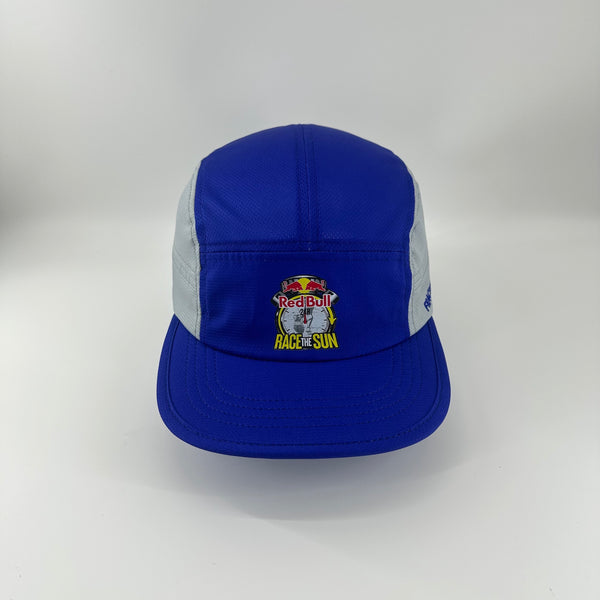 A blue and light gray Fractel M-Series cap with a Red Bull Race the Sun embroidered patch on the front, set against a plain light gray background.