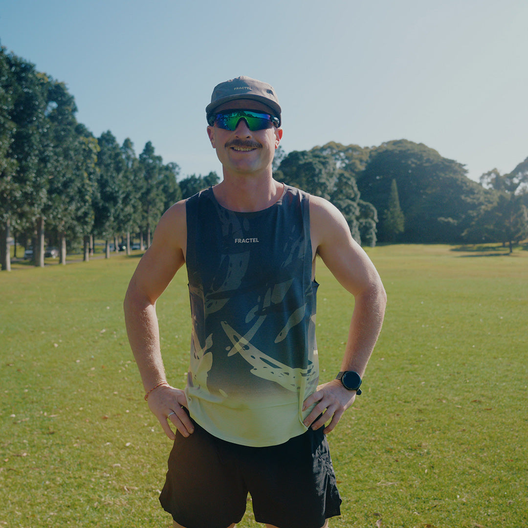 Man wearing the Fractel V-UNFURL Performance Singlet, front view