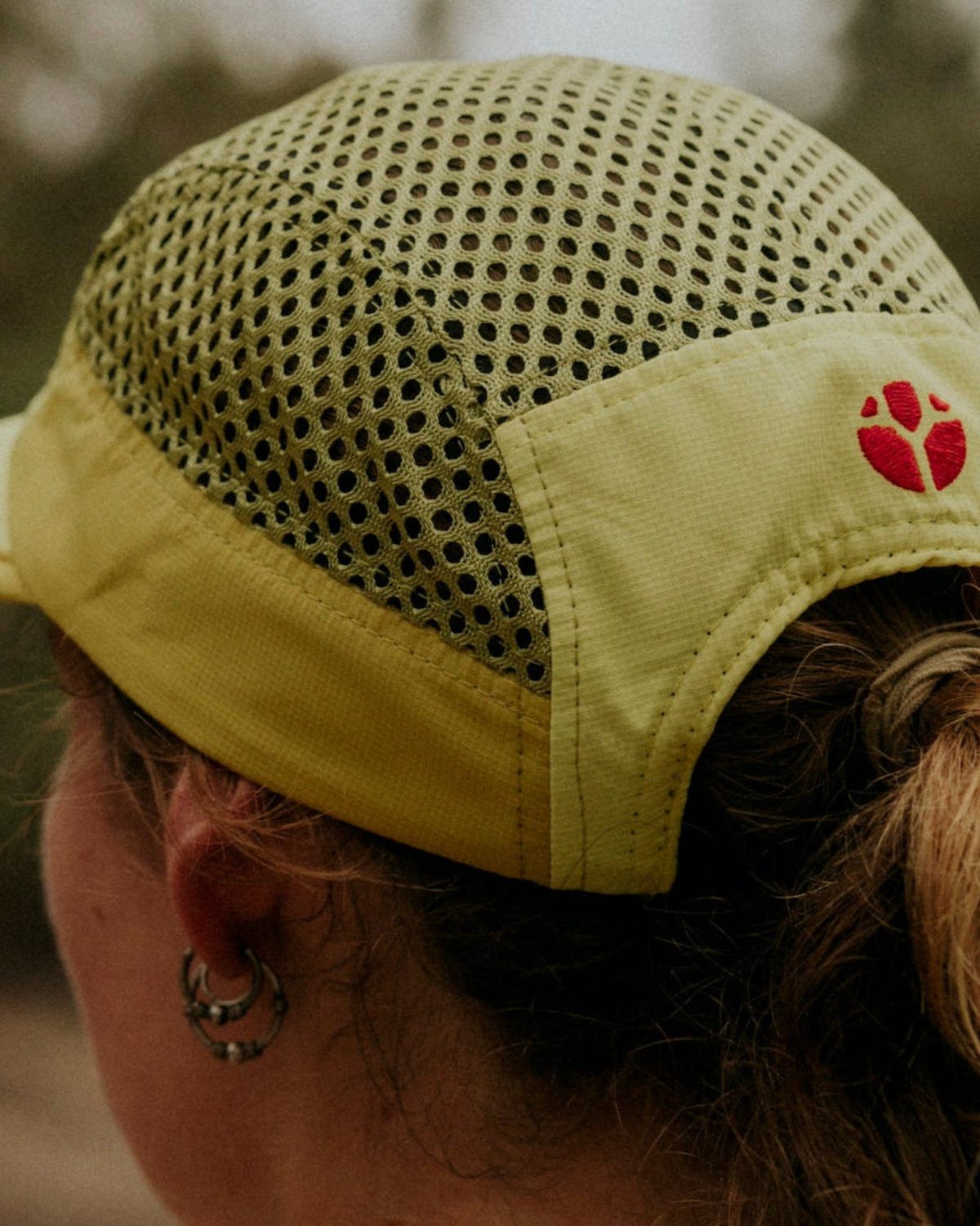 Flowmesh running fabric on a yellow Fractel cap with a red logo