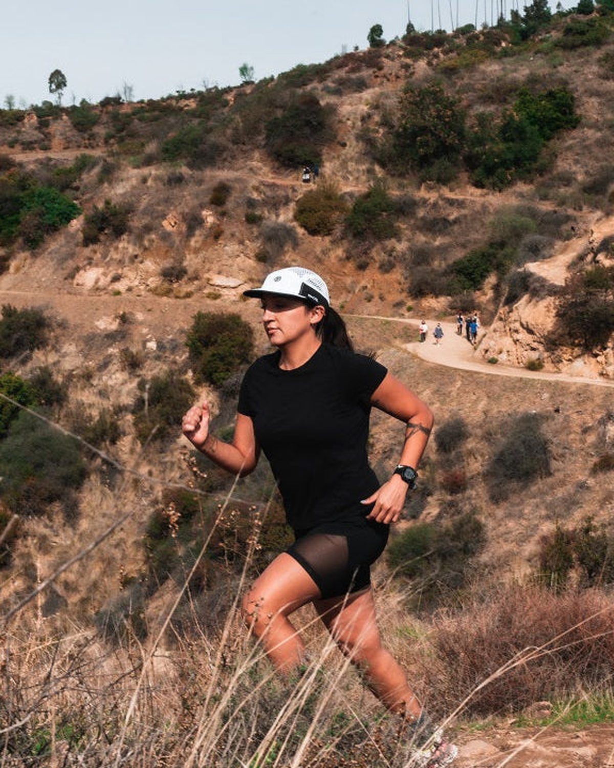 M-Series flowmesh running cap in white worn by a trail runner