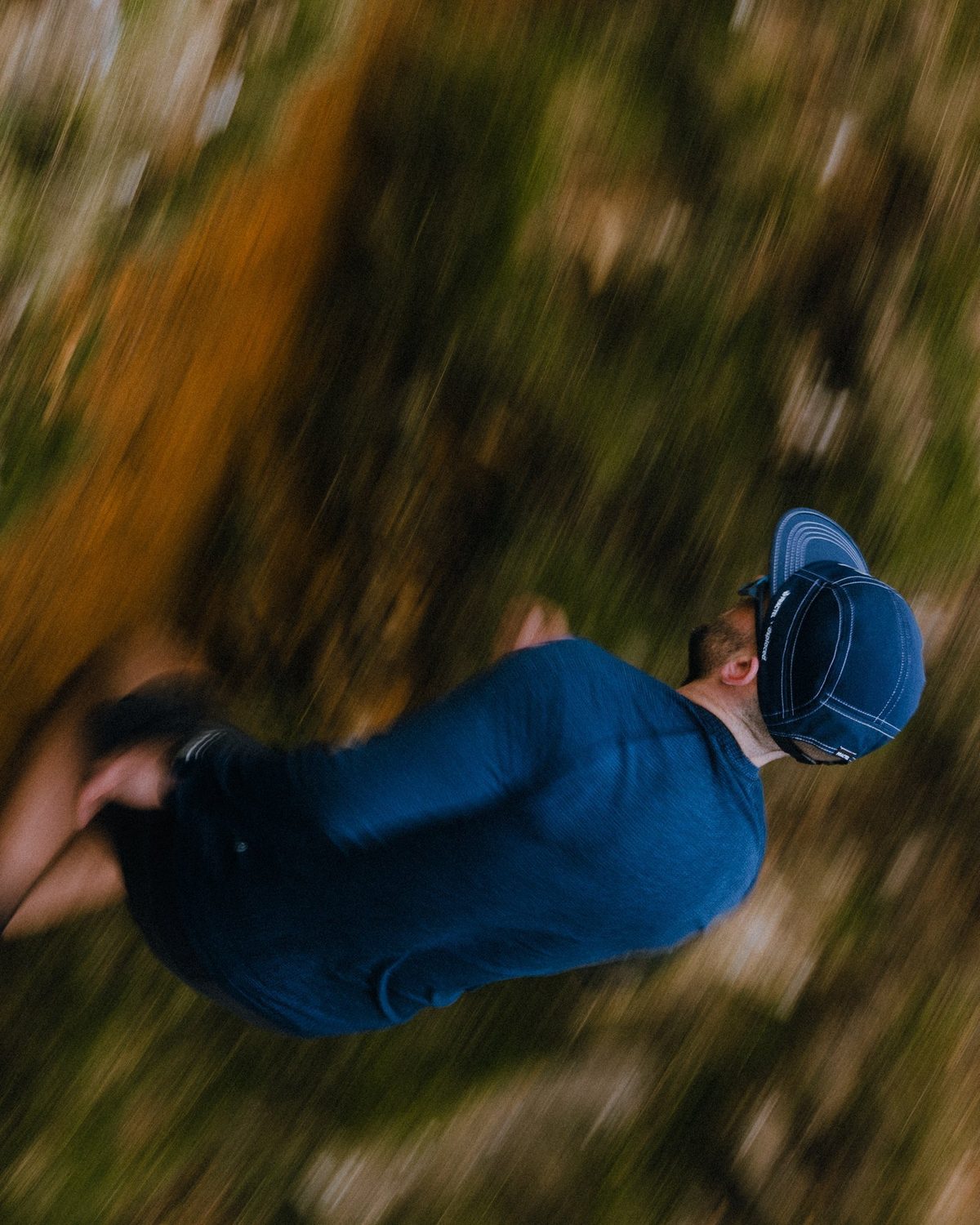 M series limited edition cap in navy worn mid-run