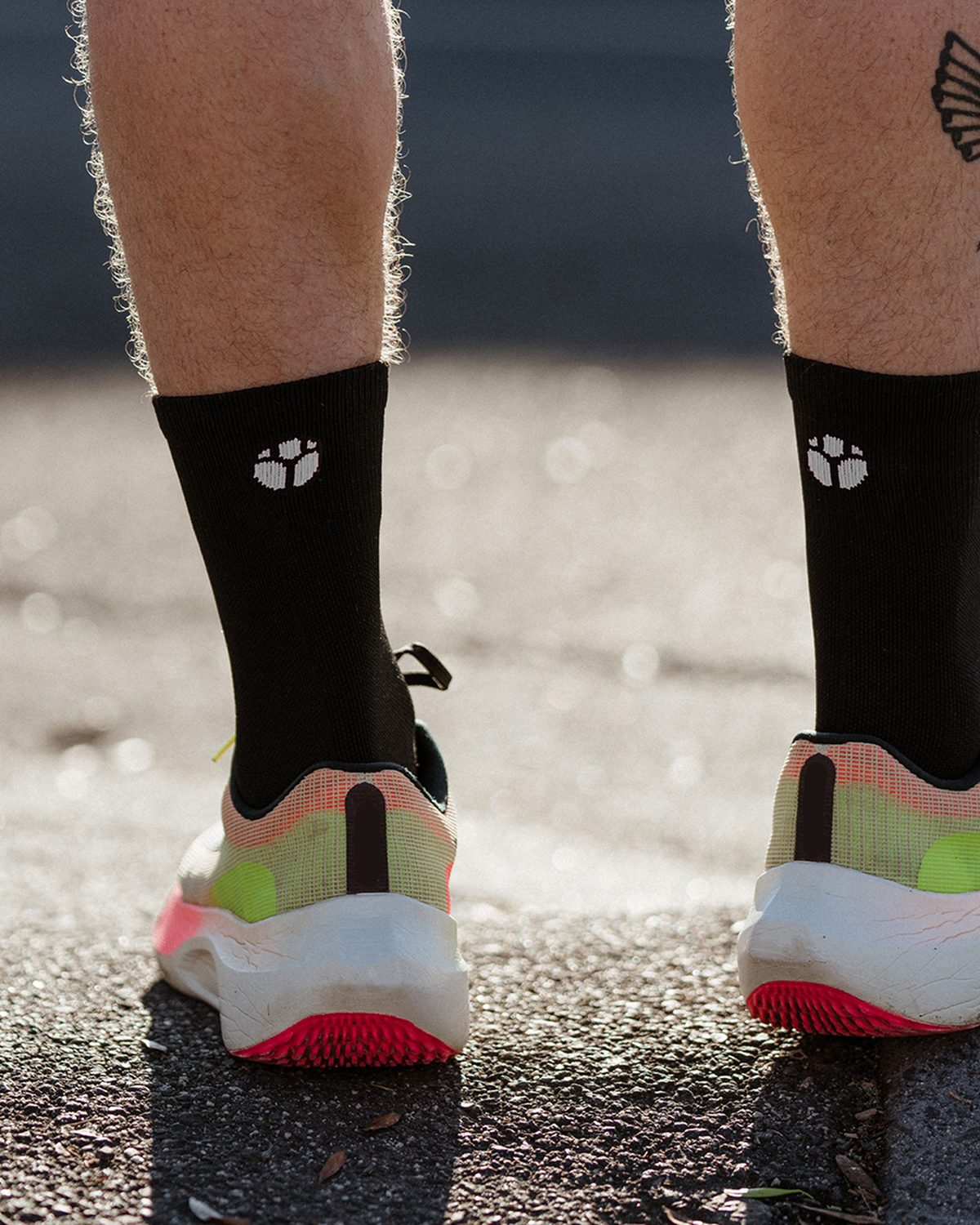 Black performance running socks with the Fractel logo