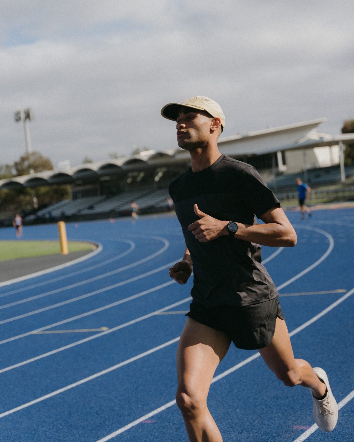 R series premium race cap collection: runner on a blue track